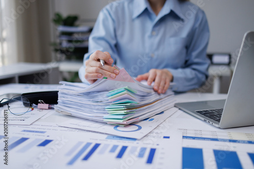 Quadro em tela Person organizing financial documents and reports on office desk
