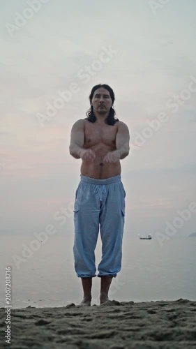 Calm Seaside Meditation. Man Hovers Gently Beneath Evening Sky. Peaceful Individual Ascends Slowly Above Sandy Shore. Tranquil Man Levitates Effortlessly Over Beach As Dusk Settles Peacefully