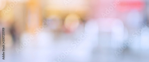 Photography An abstract blurred background with soft colors and bokeh effects, resembling a busy shopping environment or social gathering