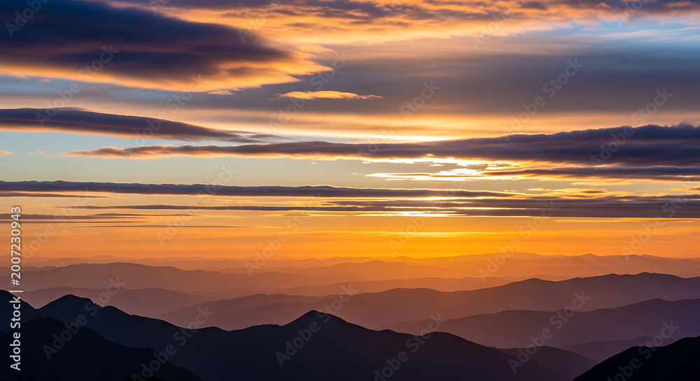 Obraz premium Sunset with clouds over mountains