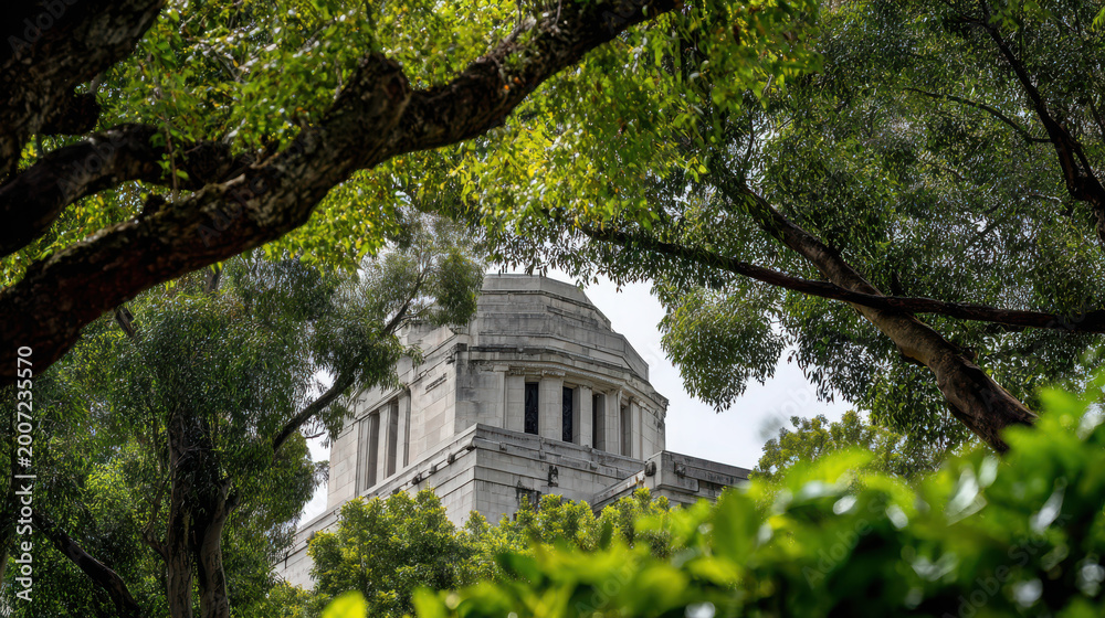 Fototapeta premium A large white building with a dome roof surrounded by green trees and bushes