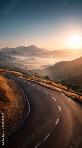 Winding Mountain Road at Sunrise with Misty Valleys