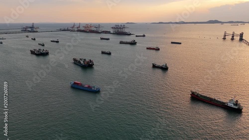 fast patrol boat with LPG gas and oil tanker ships anchored in the ocean, with a fast patrol boat in the foreground. Global energy transport, war energy crisis, and Strait of Hormuz blockade concept.	