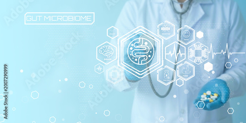 Medical professional examining gut microbiome health with futuristic digital health icons and technology visualization