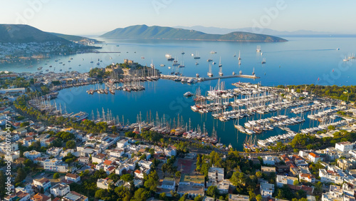 Bodrum, Turkey. Scenic coastal view from shore of Gokova Bay with Bodrum Castle, yacht marina, mountains and white houses in foreground.. Aerial View