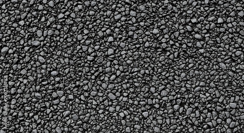 Close up macro shot of dark gray small pebbles texture background.