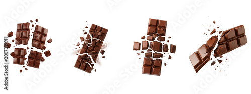 Milk chocolate bars breaking and exploding on a black background