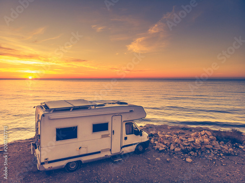 Caravan on sea coast at sunrise. Aerial view