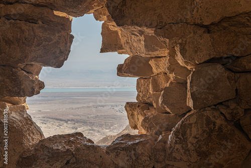 Fotografie View from ancient stone wall of Masada fortress overlooking the Dead Sea and Judean Desert, Israel