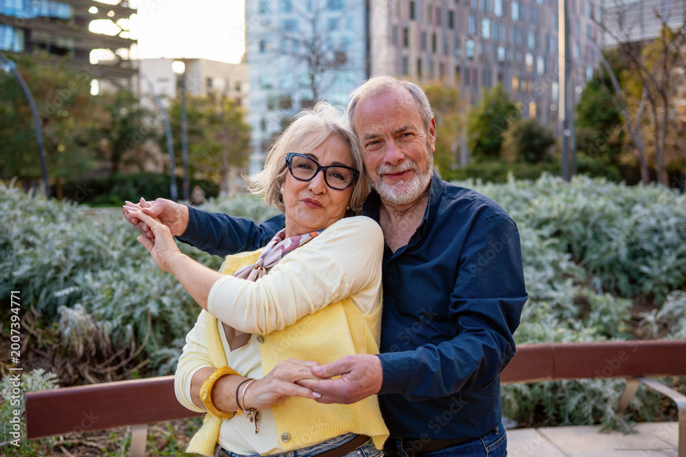 Fototapeta premium Senior couple dancing outdoors demonstrating love and happiness