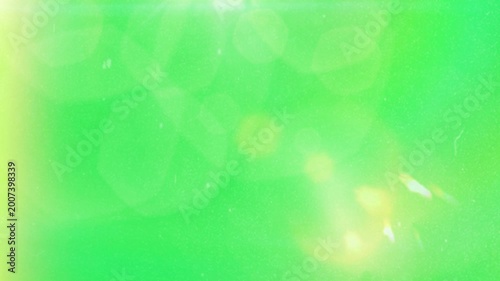 Abstract green background with soft golden light leaks and cinematic lens flare effects for motion graphic design projects and digital video overlays