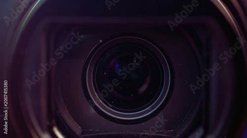 Close up macro shot of a camcorder lens focusing and adjusting aperture creating depth of field.