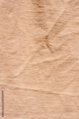 The surface of a pastel orange crew neck t-shirt.