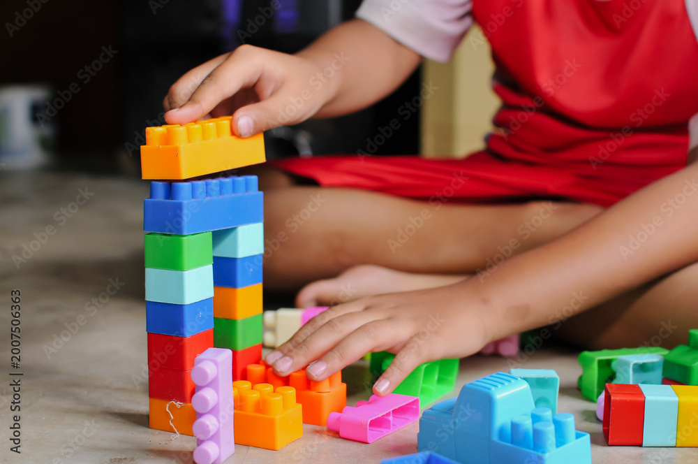 Fototapeta premium child's hands playing with lego at home