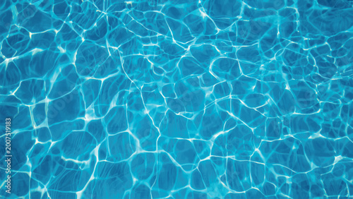 A clear turquoise swimming pool surface creates an abstract liquid texture with transparent blue ripples and sunlight reflections on the clean summer water