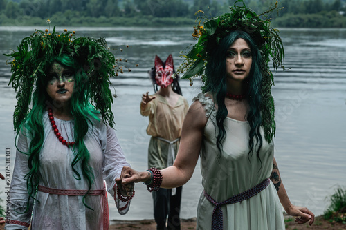 Rusalka in white with a wreath on her head and green hair