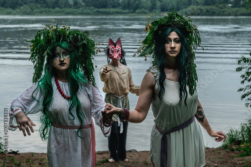 Rusalka in white with a wreath on her head and green hair