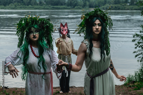 Rusalka in white with a wreath on her head and green hair