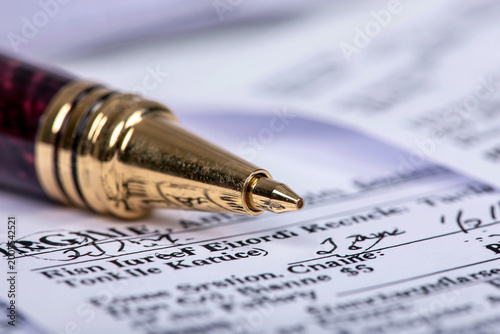 Luxury pen signing financial document close up