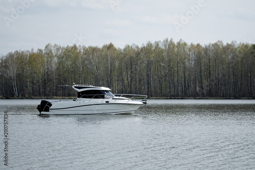 White boat on a lake. Leisure outdoor time.