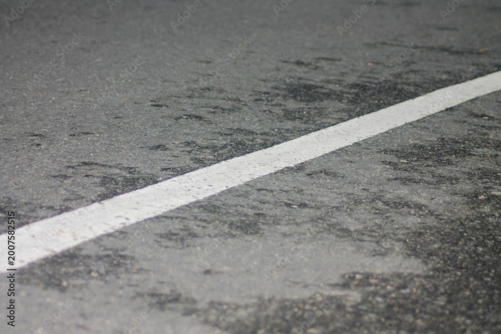 Fototapeta premium Page |12345...74Next black asphalt road with a central white line close up perspective highlighting texture and details of the surface against a dark background