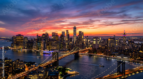 NYC Lower Manhattan skyline with Brooklyn Bridge at sunset