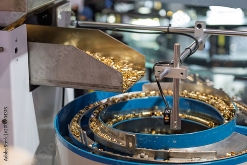 Картината върху платно Hardware factory vibrating plate conveying golden copper parts