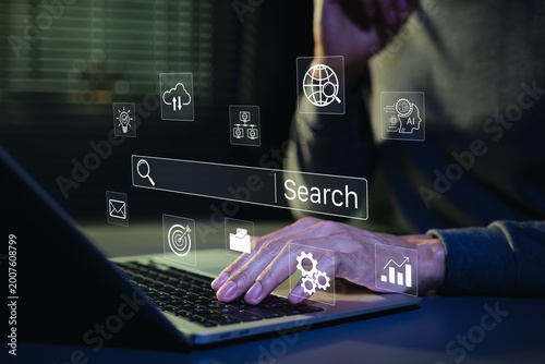 SEO search engine optimization concept. Person typing on laptop with digital search bar and marketing icons to represent web browsing data analysis, professional online discovery, AI search, SEM, GEO