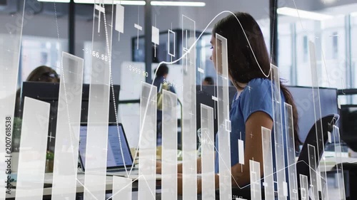 Woman typing on laptop, using mouse and scanning screen as faint finance graphs aiding analysis