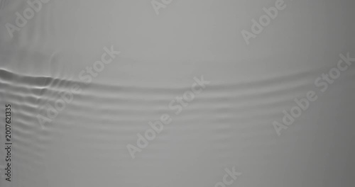 Soft ripples move gently across the calm water, creating a sense of tranquility. The light reflections form a delicate, meditative pattern. 
Video in loop.