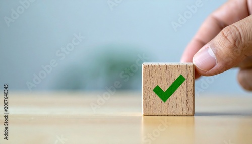 Hand Placing Wooden Block with Green Check Mark Icon for Success and Approval