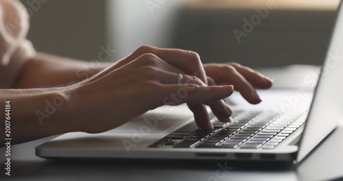 Close up of male hands typing on a vintage mechanical computer keyboard