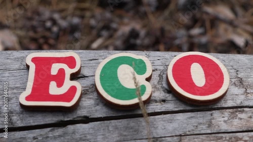 Eco word letters with straw on wood. Perfect for conveying natural, organic, or sustainable themes and messages.