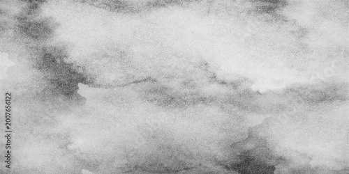 An abstract dark grunge background with old paper texture features a storm sky filled with white clouds and mist swirling through a blue night moon