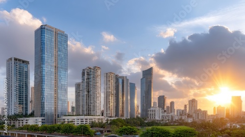 Modern Urban Skyline at Dusk with Glowing Sunset Behind Tall Glass Buildings