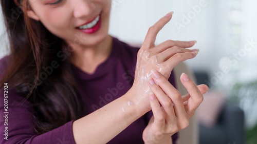 Tableau sur toile Asian women applying moisturizer hand cream lotion skincare beauty routine self