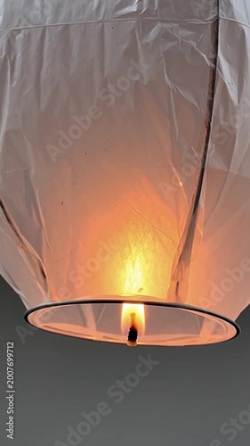 Glowing sky lantern rising into night sky — symbol of hope, celebration, and traditional Asian festivals