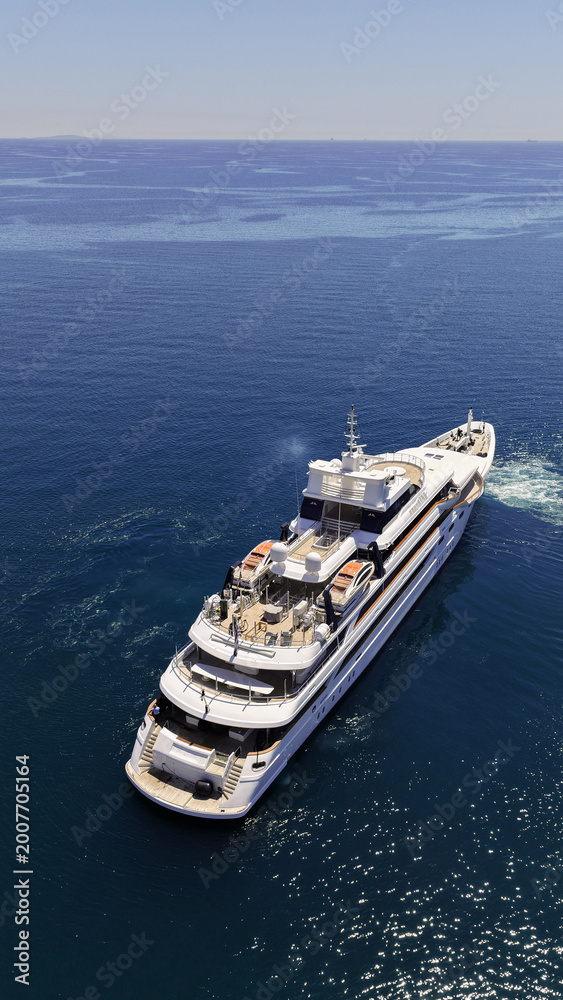 Obraz premium Aerial drone photo of luxury yacht with wooden deck cruising deep blue Aegean open sea
