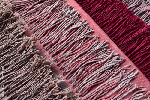 Close-up of colorful warm wool scarves with tassels