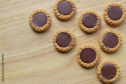 Cookies with chocolate filling on a wooden background