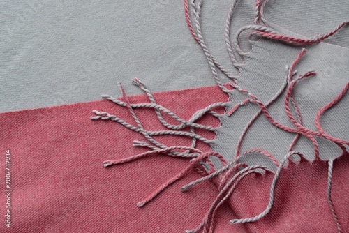 Colorful wool scarf with tassels. Gray and pink wool scarf with tassels