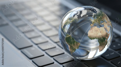 A close-up view of a globe on top of a computer keyboard.