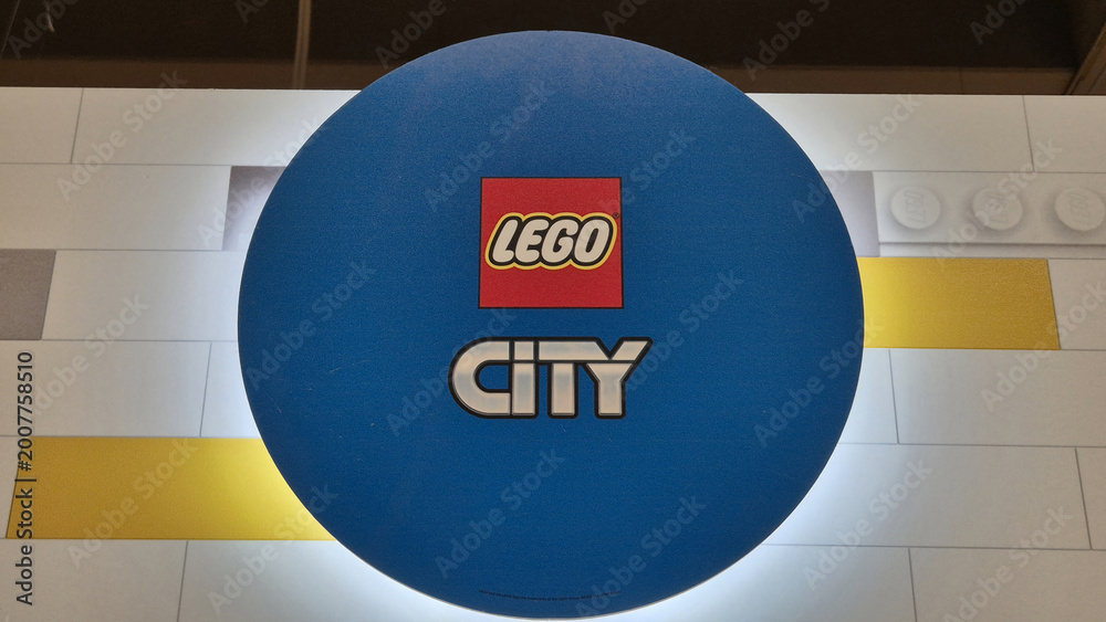 Fototapeta premium A circular blue LEGO City sign displaying the red brand logo above the silver and white City series wordmark. Picture taken on April 27, 2026 in Bucharest, Romania.