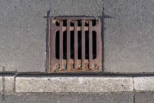 cast-iron storm drain at the roadside