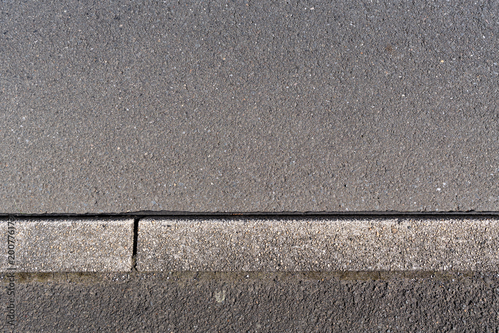 Fototapeta premium paved road surface and concrete curb