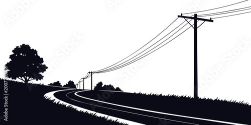 Obraz na płótnie Silhouetted utility poles with power lines stretching along a winding road in a