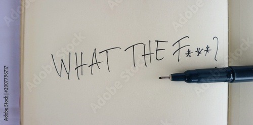 Fotografía A text containing sentences with harsh meanings is written in the middle of the book using a drawing pen placed near the text