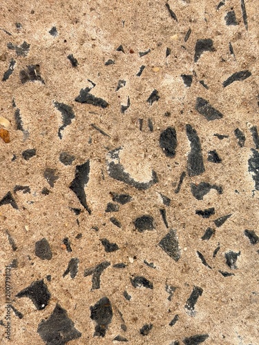 Concrete terrazzo texture background summer outdoor pavement surface with rough cement and black stone chips for construction and architectural design.