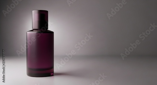 Elegant perfume bottle with dark glass and a sleek design on a neutral background.