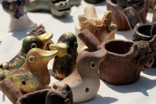 Photography Colorful ceramic birds and animals displayed at a lively market